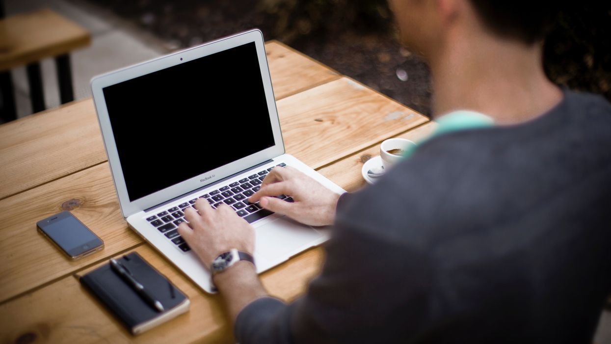 author in front of laptop computer ready to type