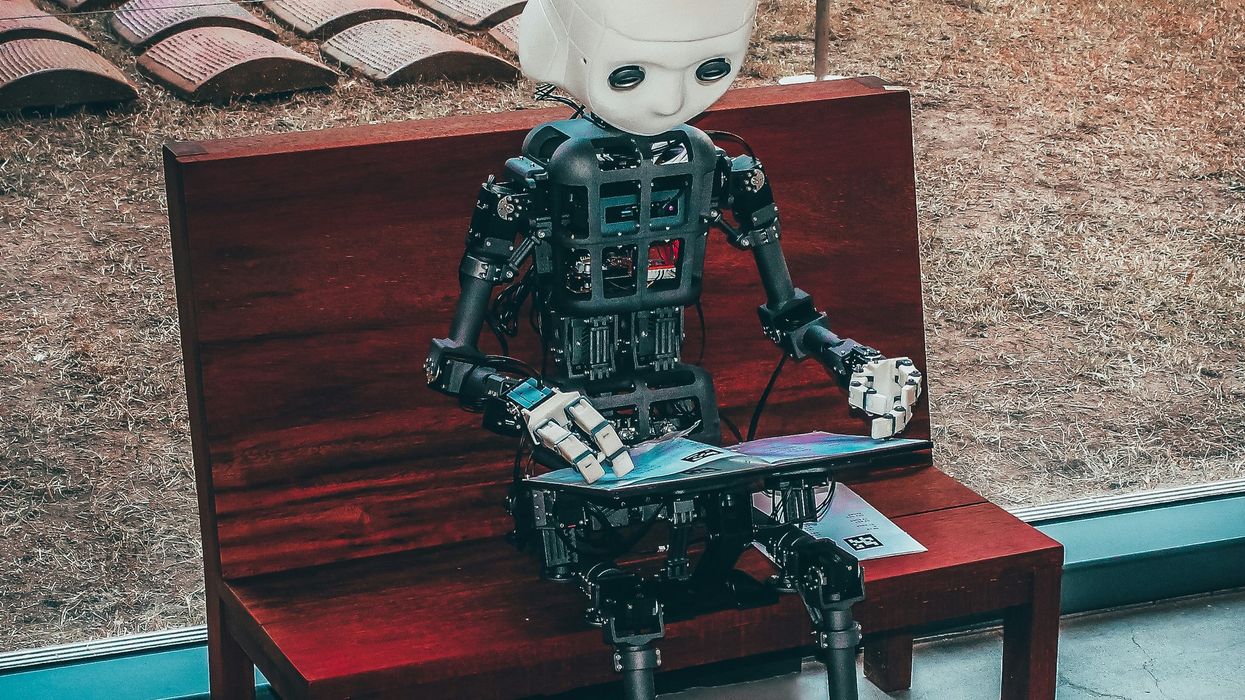 black and white robot toy on red wooden table