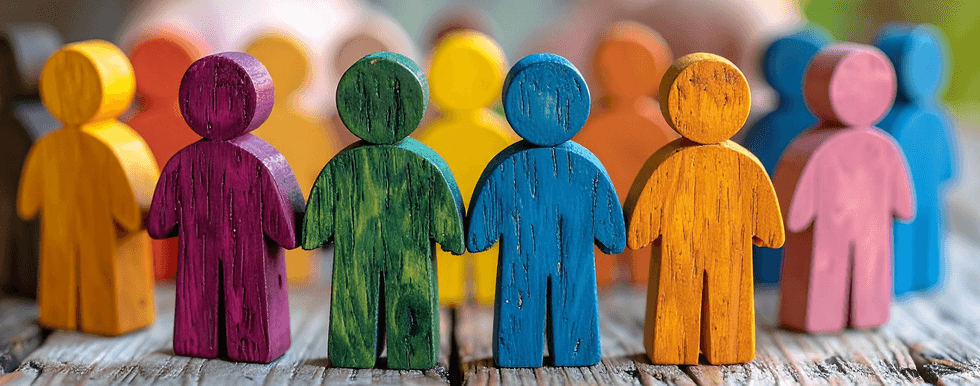 Colorful wooden figures standing together on a wooden surface.