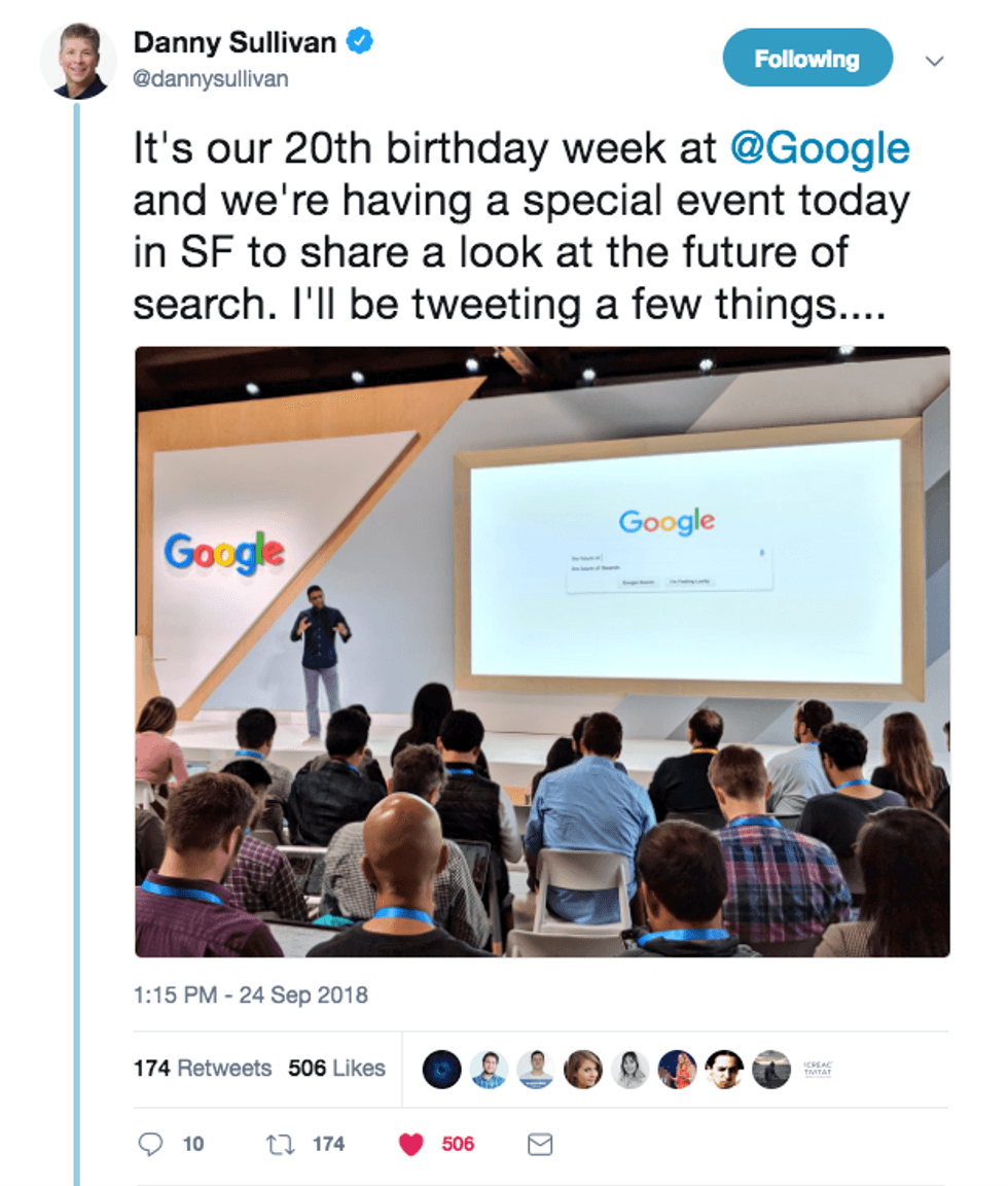 Google event with a speaker on stage, audience seated, and presentation screen.