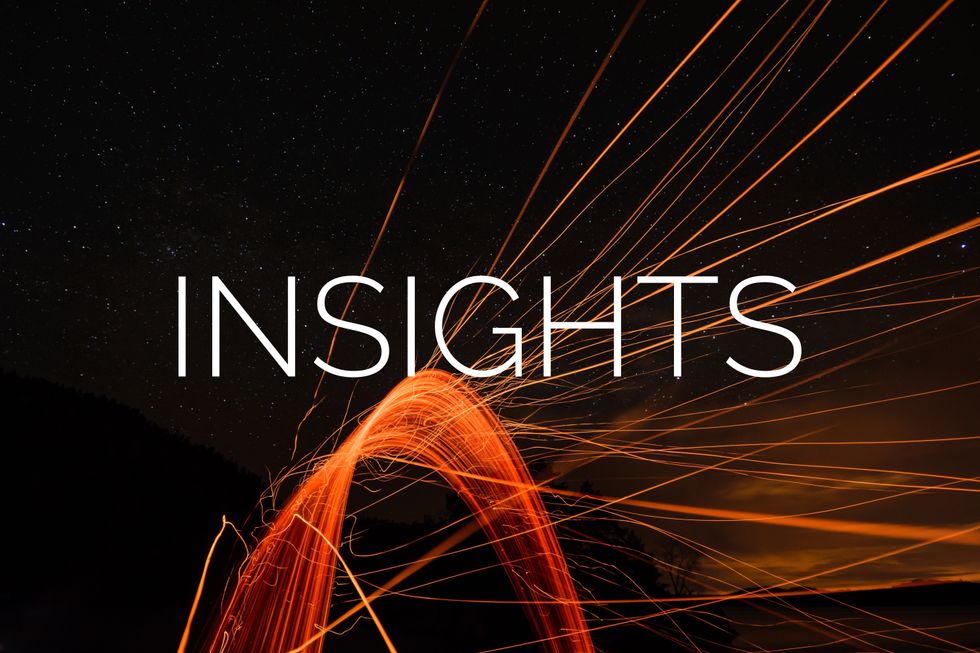 "INSIGHTS" over a night sky with dynamic light trails.