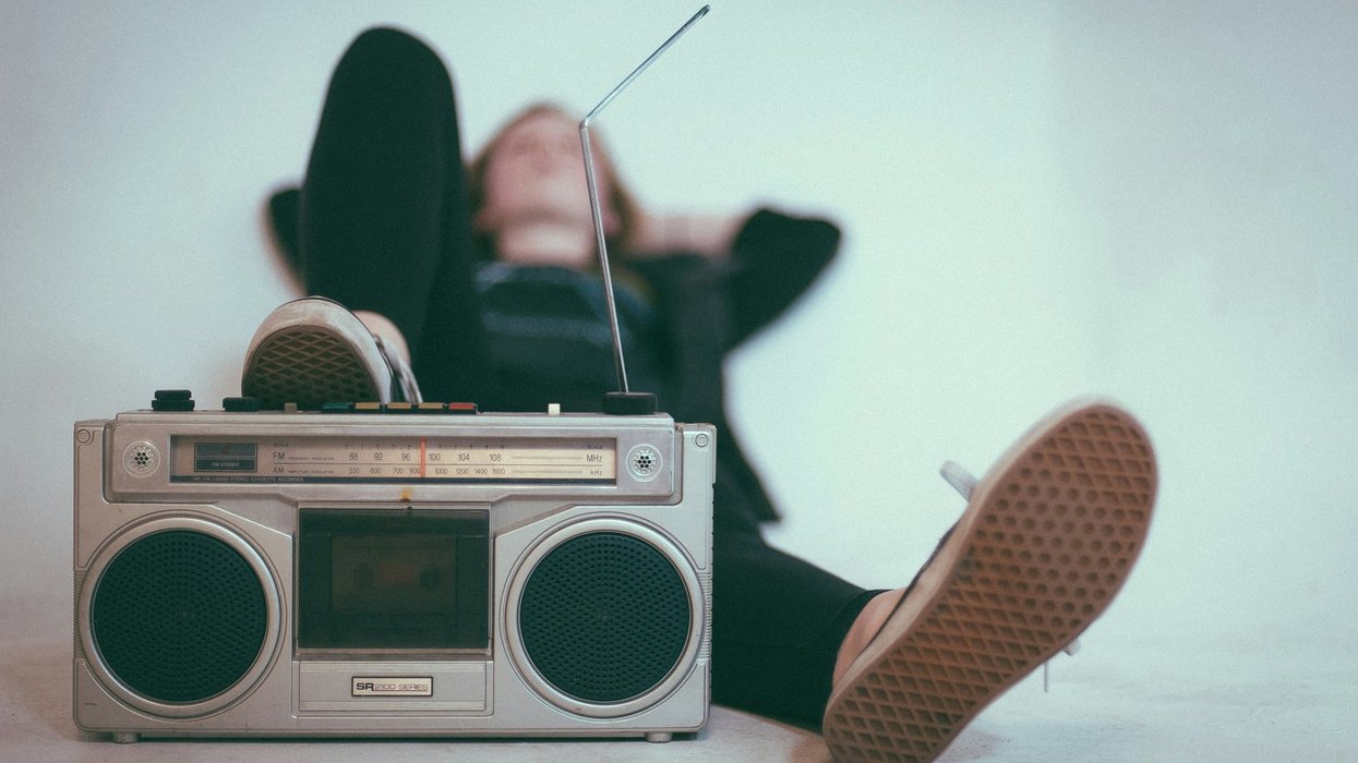 person relaxing near gray radio
