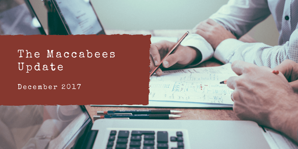 "The Maccabees Update December 2017, with people reviewing documents on a desk."